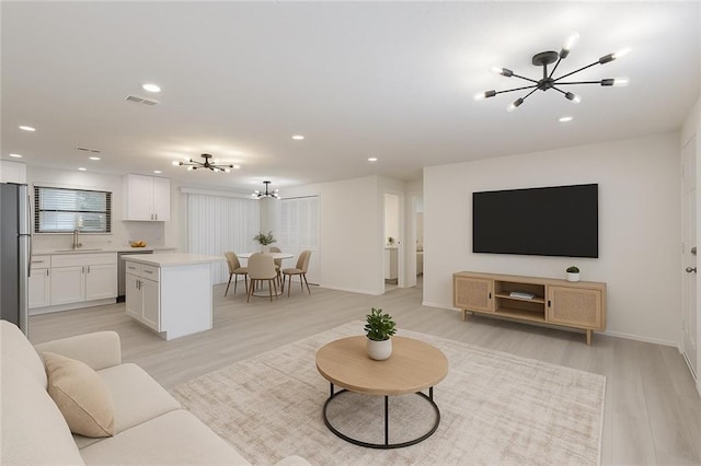 4922 Glenside Ct, Stone Mountain, GA 30088 - living room with a chandelier, light wood-style flooring, recessed lighting, and baseboards
