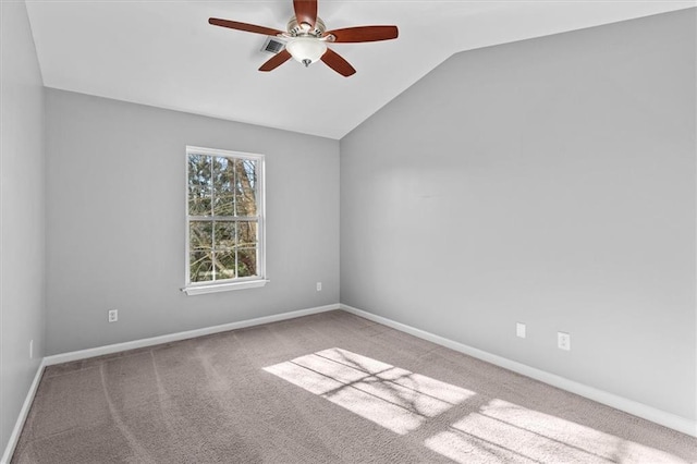 unfurnished room featuring carpet floors, lofted ceiling, ceiling fan, and baseboards