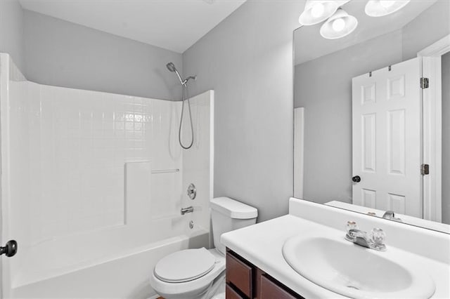 bathroom featuring toilet,  shower combination, and vanity