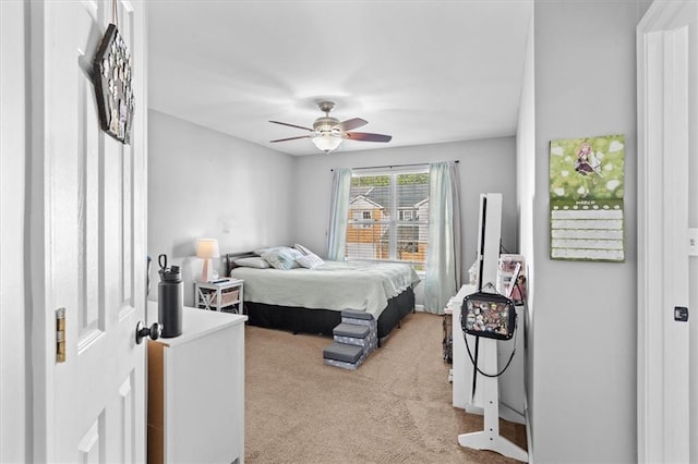 bedroom featuring ceiling fan and light colored carpet