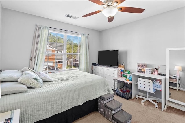 bedroom featuring light colored carpet, visible vents, and ceiling fan