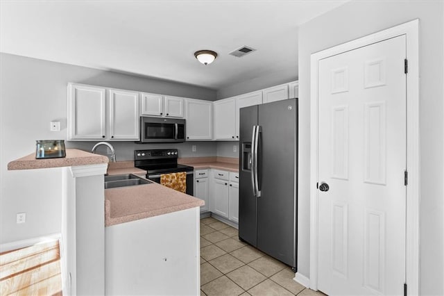 kitchen with light tile patterned floors, visible vents, appliances with stainless steel finishes, white cabinets, and a sink