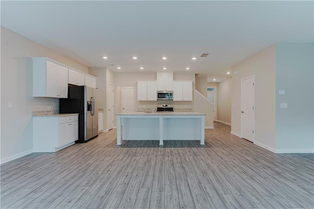 kitchen featuring stainless steel appliances, light wood-style flooring, white cabinetry, and recessed lighting