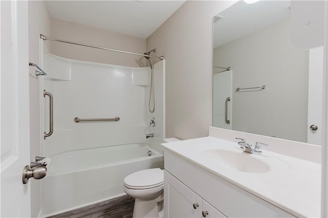 bathroom with toilet, wood finished floors, vanity, and shower / tub combination