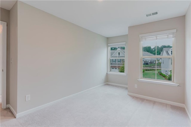 empty room with light carpet and baseboards