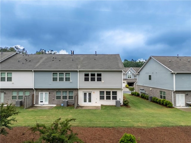 back of house with french doors, a patio area, central AC unit, and a lawn
