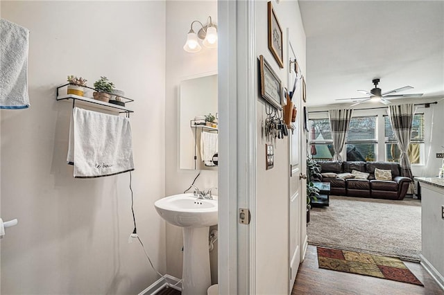 bathroom with hardwood / wood-style floors and ceiling fan