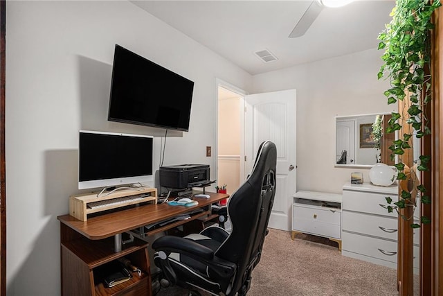 carpeted office space featuring ceiling fan