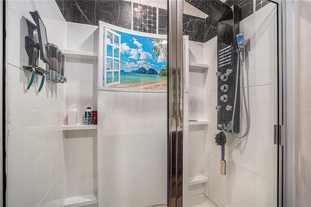 bathroom featuring a shower with door