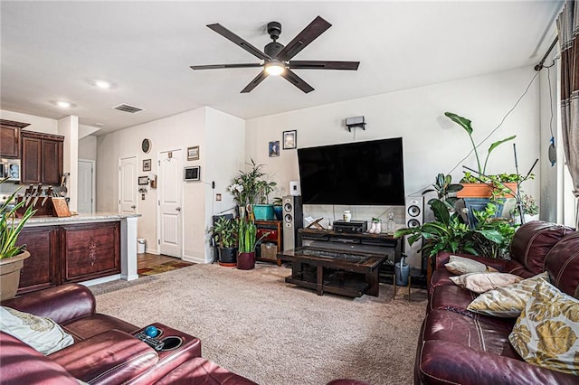 carpeted living room featuring ceiling fan