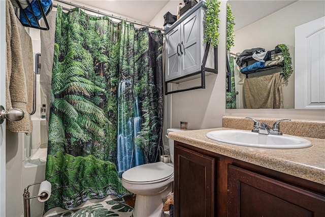 bathroom featuring curtained shower, vanity, and toilet