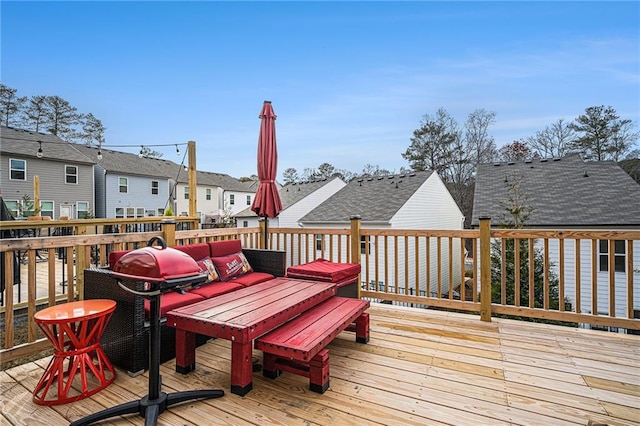 wooden terrace with an outdoor hangout area