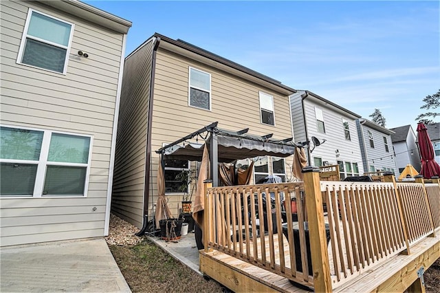 back of house with a pergola and a deck