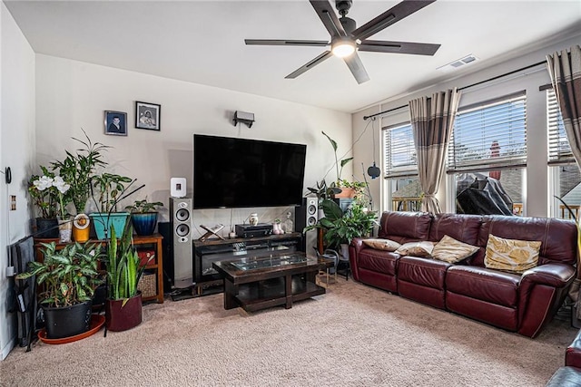 living room featuring carpet flooring and ceiling fan