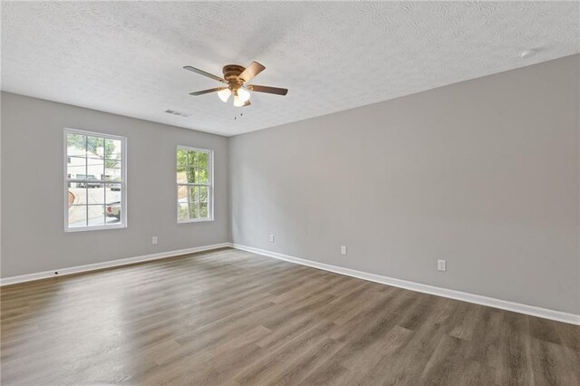 2599 Willow Creek Dr, Duluth, GA 30096 - unfurnished room featuring wood finished floors, ceiling fan, a textured ceiling, and baseboards