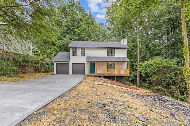 2599 Willow Creek Dr, Duluth, GA 30096 - view of front of home with a chimney, driveway, a porch, a shingled roof, and an attached garage