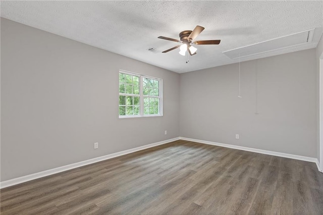 2599 Willow Creek Dr, Duluth, GA 30096 - unfurnished room with attic access, dark wood-style flooring, a textured ceiling, a ceiling fan, and baseboards