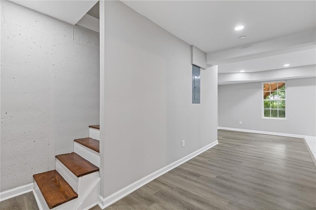 2599 Willow Creek Dr, Duluth, GA 30096 - below grade area featuring wood finished floors, electric panel, stairs, baseboards, and recessed lighting