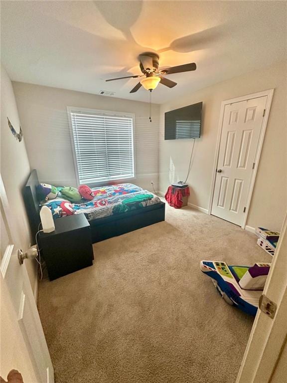 bedroom featuring a ceiling fan, carpet flooring, baseboards, and visible vents