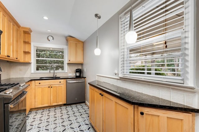 kitchen with sink, vaulted ceiling, tasteful backsplash, decorative light fixtures, and stainless steel appliances