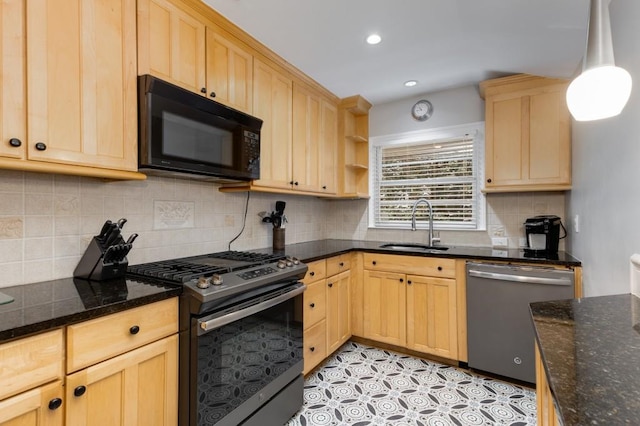 kitchen with pendant lighting, sink, dark stone countertops, appliances with stainless steel finishes, and light tile patterned flooring