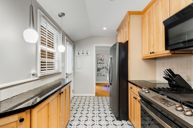 kitchen featuring backsplash, stainless steel appliances, decorative light fixtures, dark stone countertops, and lofted ceiling