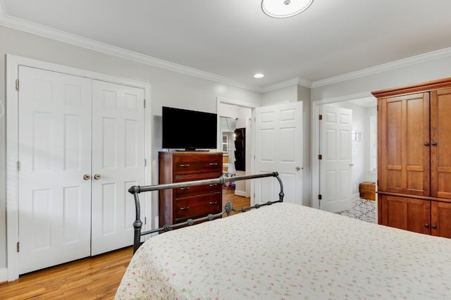 bedroom featuring crown molding and light hardwood / wood-style flooring