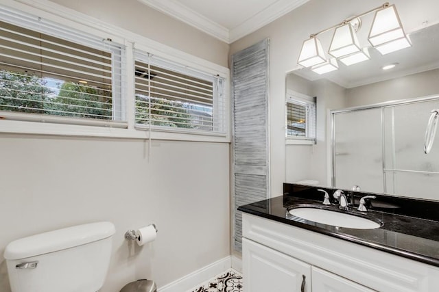 bathroom with vanity, toilet, a shower with shower door, and crown molding