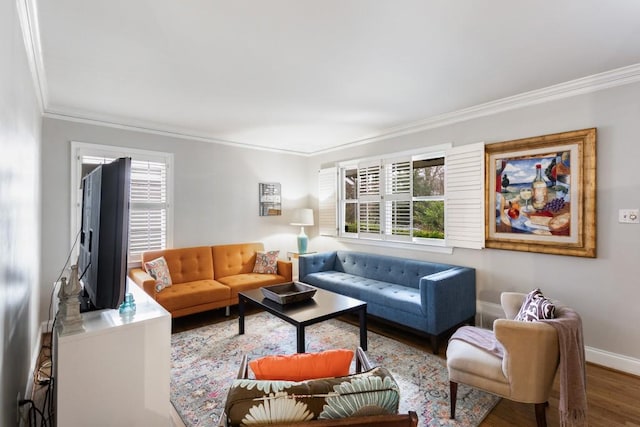 living room with a healthy amount of sunlight, hardwood / wood-style flooring, and crown molding