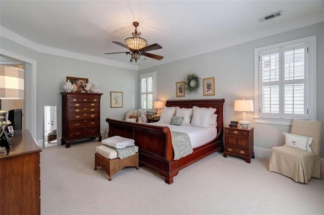 bedroom with light carpet, ceiling fan, and crown molding