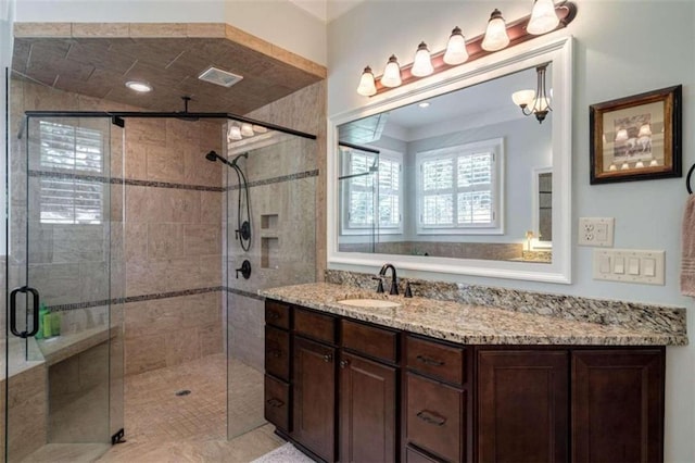 full bathroom with a shower stall and vanity