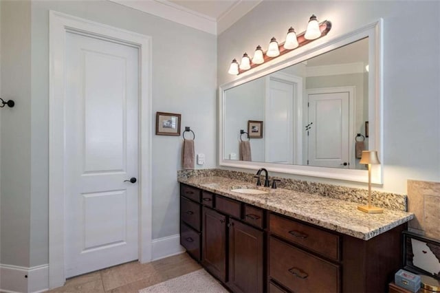 bathroom with crown molding, baseboards, and vanity