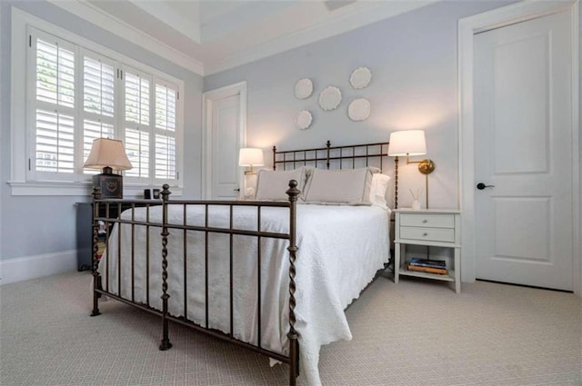 carpeted bedroom featuring crown molding and baseboards