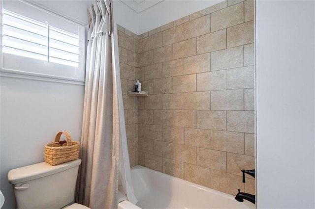 bathroom with toilet and shower / bath combination with curtain