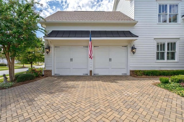 garage featuring decorative driveway