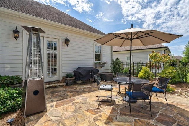 view of patio / terrace featuring area for grilling, fence, and outdoor dining area