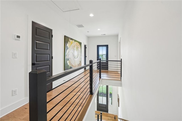 stairway featuring baseboards, visible vents, attic access, and a wealth of natural light