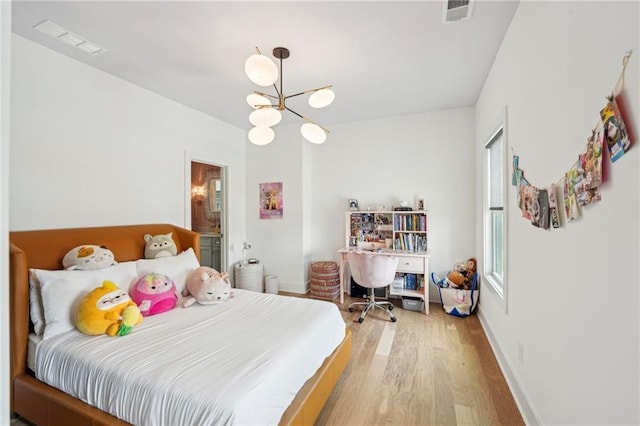 bedroom with an inviting chandelier, baseboards, light wood-style flooring, and visible vents