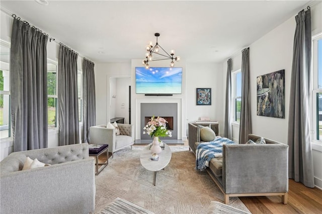 living room with a notable chandelier and wood finished floors