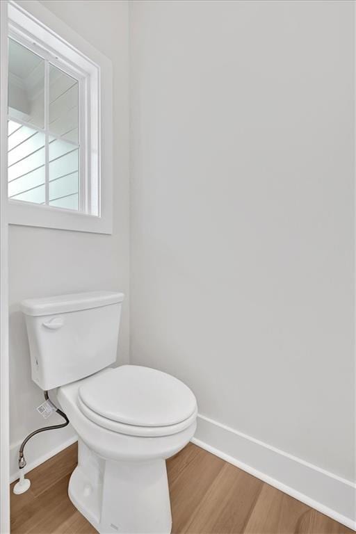 bathroom featuring hardwood / wood-style flooring and toilet