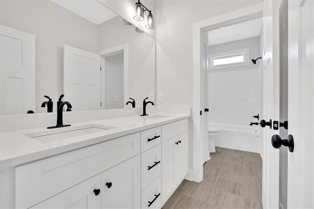 full bathroom with shower / washtub combination, vanity, and toilet