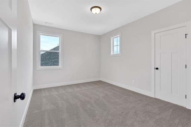 carpeted spare room with a healthy amount of sunlight