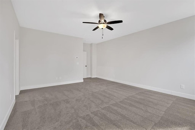 empty room featuring carpet floors and ceiling fan