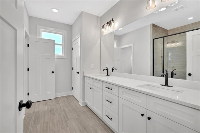 bathroom with vanity and a shower with shower door