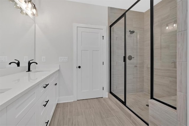 bathroom featuring vanity and a shower with shower door