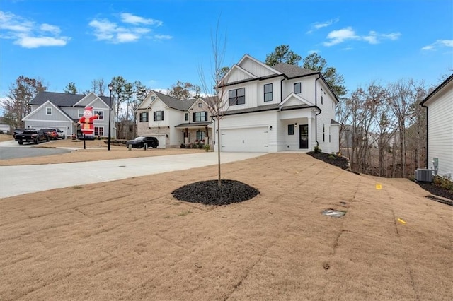 view of front of house with central AC and a garage