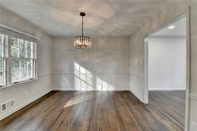 spare room with a notable chandelier and dark hardwood / wood-style flooring