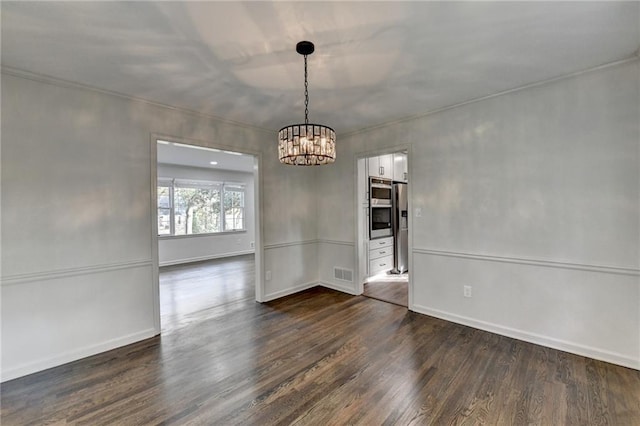 unfurnished dining area featuring an inviting chandelier and dark hardwood / wood-style floors