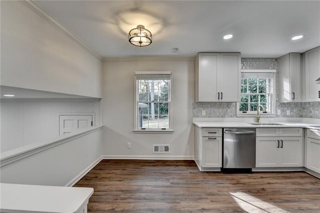 kitchen featuring dark wood-type flooring, sink, backsplash, and stainless steel dishwasher