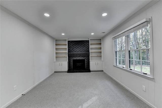 unfurnished living room featuring carpet floors, built in features, ornamental molding, and a fireplace